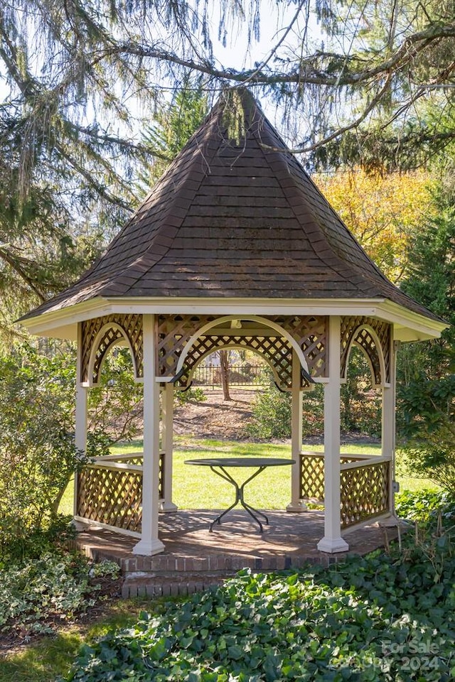 surrounding community with a gazebo and a lawn