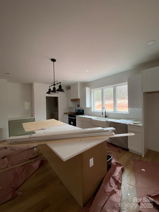 kitchen featuring black stove, white cabinetry, light hardwood / wood-style flooring, dishwasher, and pendant lighting