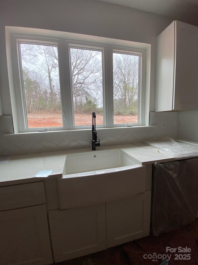 kitchen with sink, backsplash, and dishwasher