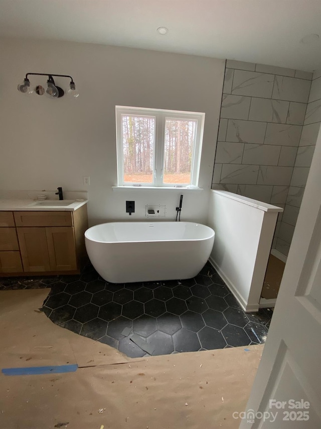 bathroom with vanity, a bath, and tile patterned flooring