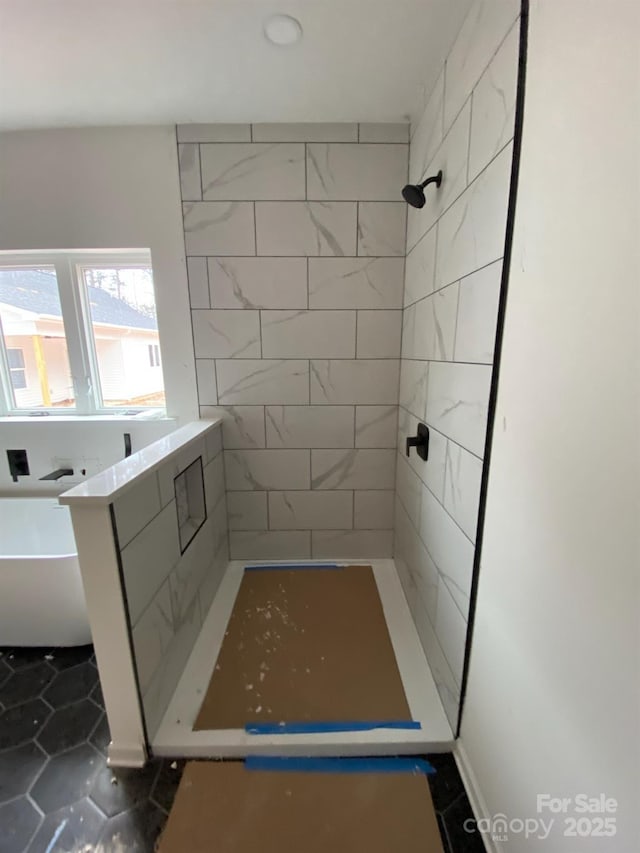 bathroom featuring a tile shower