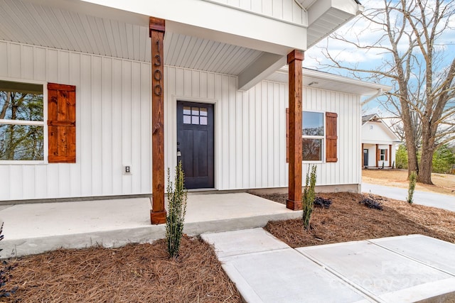 doorway to property featuring board and batten siding