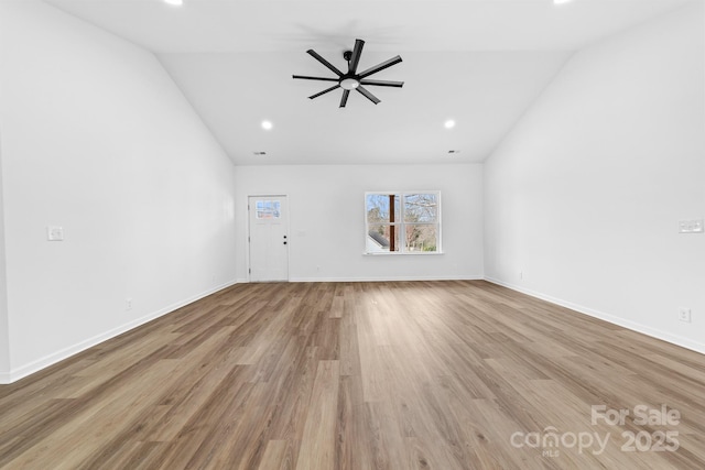 unfurnished living room with baseboards, lofted ceiling, a ceiling fan, and wood finished floors