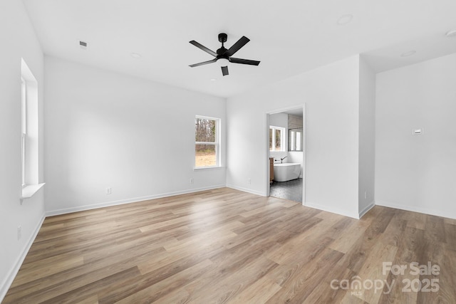 unfurnished bedroom featuring visible vents, connected bathroom, ceiling fan, baseboards, and light wood-style floors