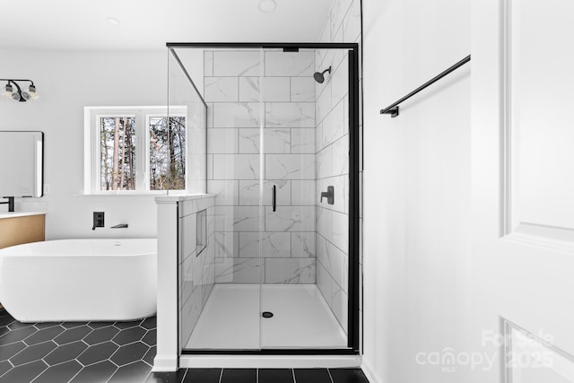 full bathroom featuring a soaking tub, a stall shower, and vanity