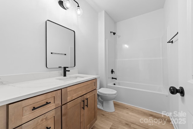 full bathroom with vanity, shower / tub combination, toilet, and wood finished floors
