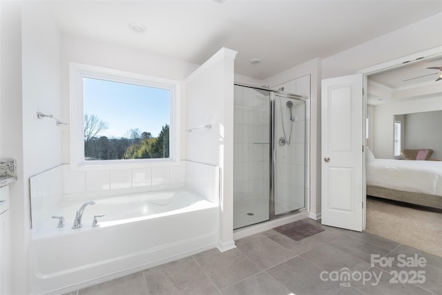 bathroom with tile patterned floors and independent shower and bath