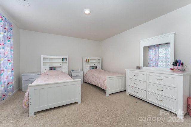 bedroom featuring light carpet