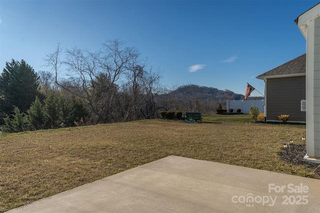 view of yard featuring a mountain view and a patio area