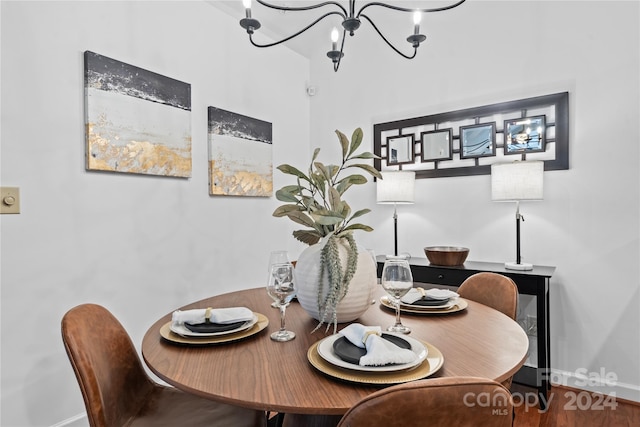 dining area with a notable chandelier and hardwood / wood-style flooring