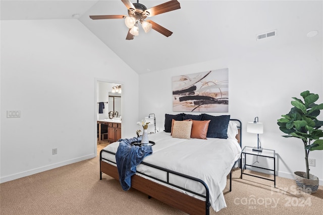 carpeted bedroom with ensuite bath, ceiling fan, and high vaulted ceiling