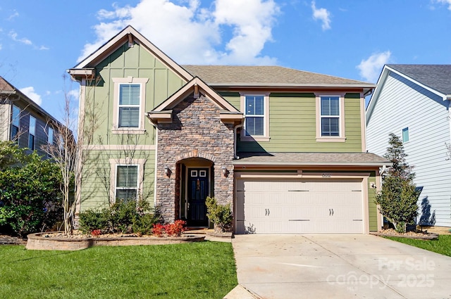 view of front of house featuring a garage, concrete driveway, stone siding, a front lawn, and board and batten siding