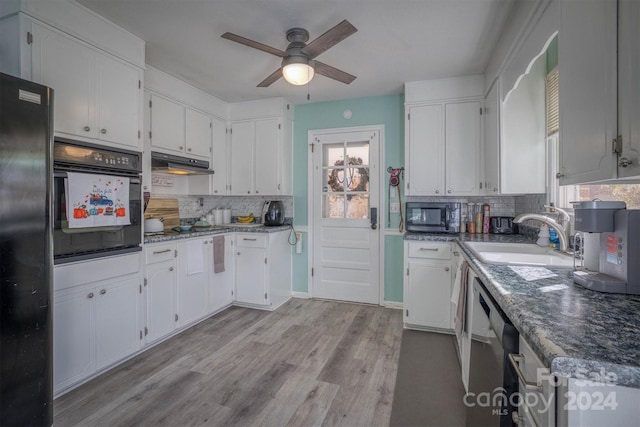 kitchen featuring black appliances, tasteful backsplash, sink, and light hardwood / wood-style flooring