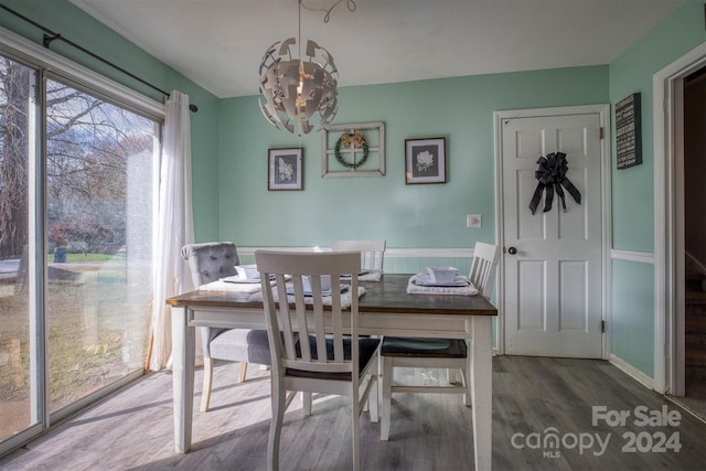 dining area featuring a chandelier and wood-type flooring