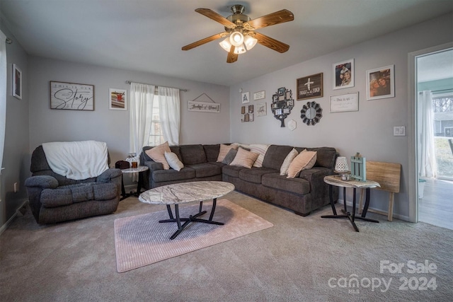 living room featuring ceiling fan, a healthy amount of sunlight, and light carpet