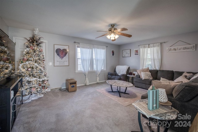 carpeted living room with ceiling fan and a healthy amount of sunlight