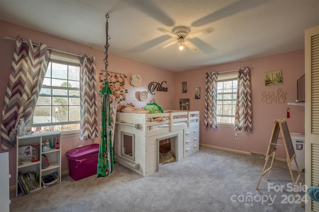 interior space with ceiling fan, light colored carpet, and a textured ceiling