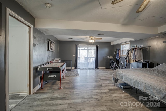 bedroom with ceiling fan and hardwood / wood-style flooring