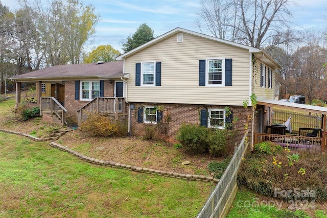 tri-level home with a front lawn