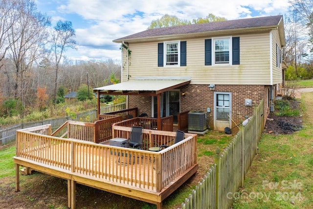 back of house featuring a wooden deck and cooling unit