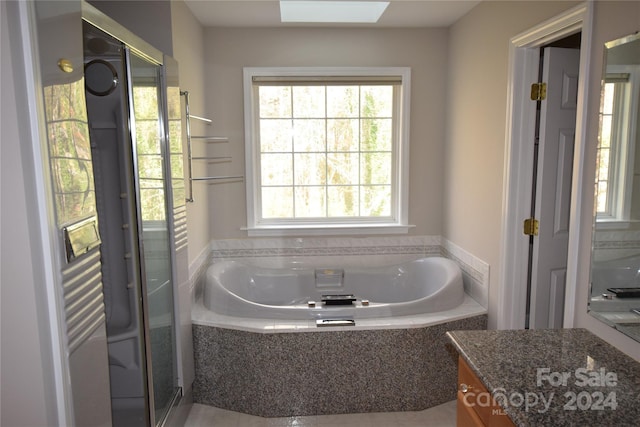 bathroom with vanity and independent shower and bath