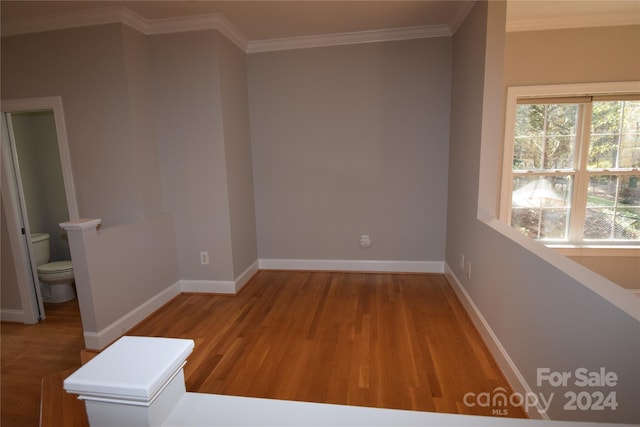 unfurnished room featuring hardwood / wood-style flooring and crown molding