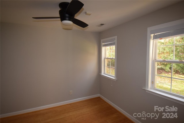 unfurnished room featuring ceiling fan and hardwood / wood-style floors