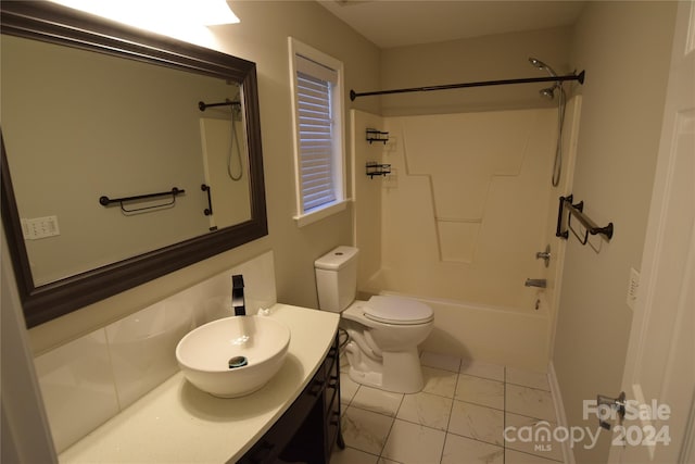 full bathroom featuring washtub / shower combination, vanity, and toilet