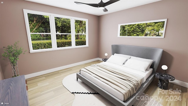 bedroom with ceiling fan and light hardwood / wood-style flooring