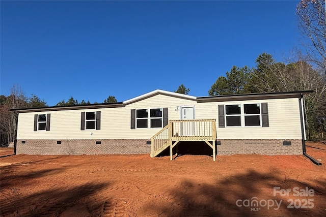 rear view of house featuring a deck