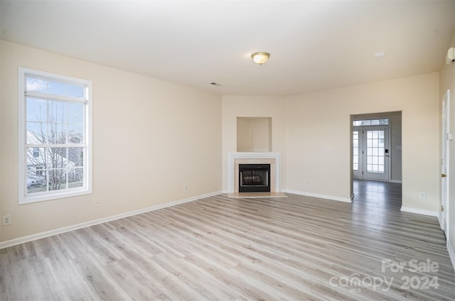 unfurnished living room with light hardwood / wood-style floors