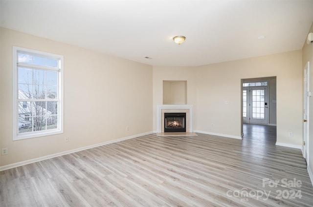 unfurnished living room with light wood-type flooring