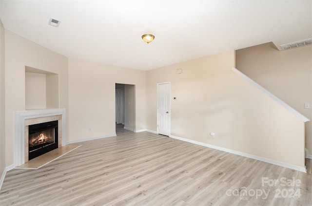 unfurnished living room featuring light hardwood / wood-style floors