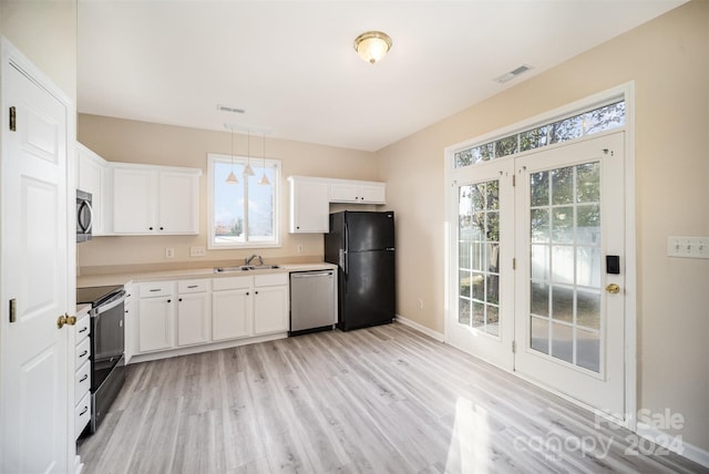 kitchen with black appliances, light wood-type flooring, white cabinetry, and sink