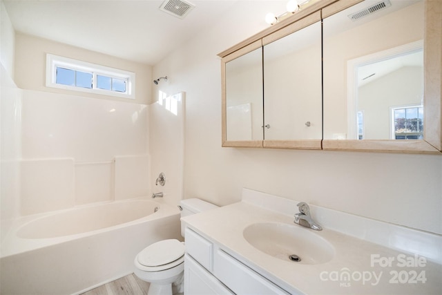 full bathroom featuring hardwood / wood-style flooring, plenty of natural light, vaulted ceiling, and toilet