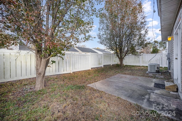 view of yard featuring cooling unit and a patio