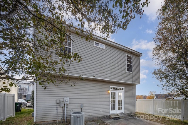 rear view of house featuring central AC unit and french doors