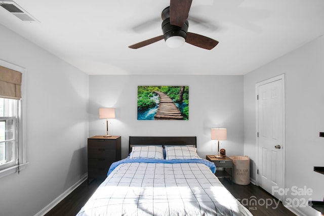 bedroom with ceiling fan and dark wood-type flooring