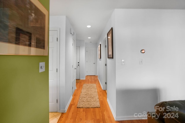 corridor with light hardwood / wood-style flooring