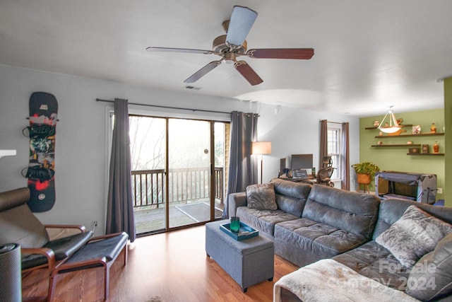 living room featuring hardwood / wood-style flooring, a wealth of natural light, and ceiling fan