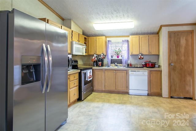 kitchen featuring a textured ceiling, crown molding, sink, and stainless steel appliances