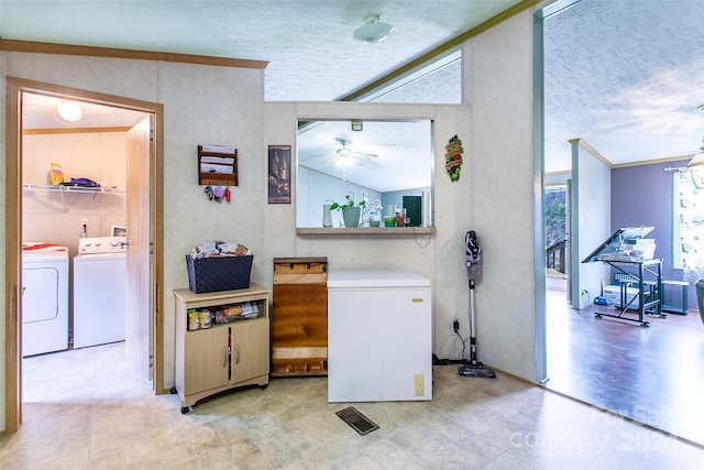 laundry area with independent washer and dryer, a textured ceiling, light hardwood / wood-style flooring, and ceiling fan