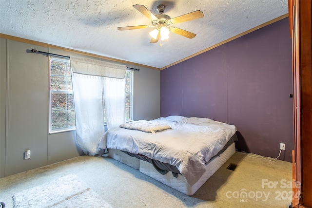 carpeted bedroom with a textured ceiling, ceiling fan, crown molding, and lofted ceiling