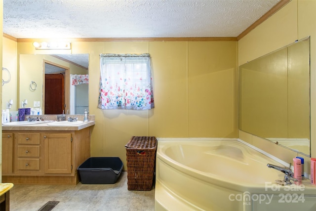 bathroom with vanity, a textured ceiling, and a tub