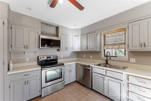 kitchen with ceiling fan, sink, light tile patterned floors, and stainless steel appliances