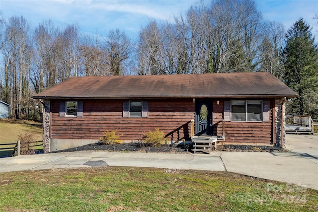 ranch-style home with a front lawn