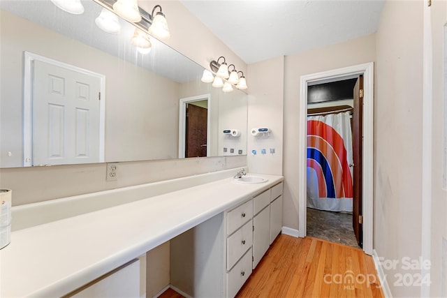 bathroom featuring hardwood / wood-style floors and vanity