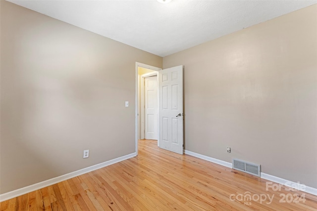 spare room with light wood-type flooring