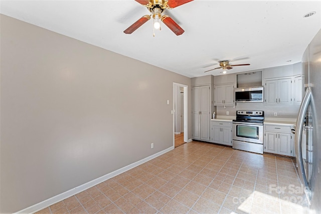 kitchen featuring gray cabinets, ceiling fan, and appliances with stainless steel finishes