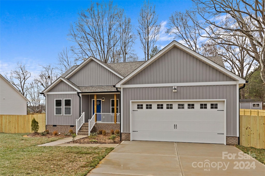 craftsman inspired home with covered porch and a garage